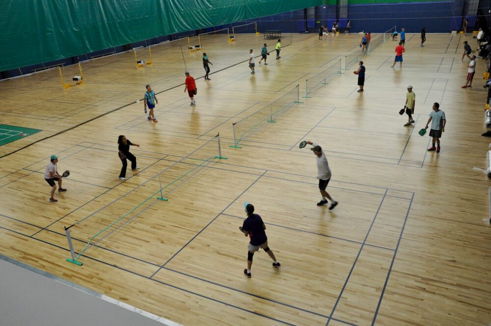 Overhead view of players playing pickleball