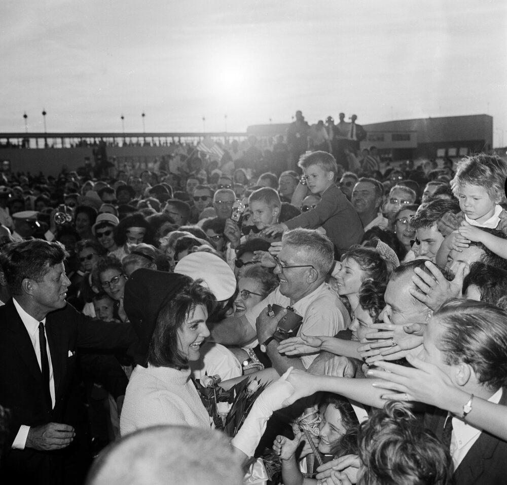 President John F. Kennedy and first lady Jacqueline Kennedy shake hands with well-wishers who lined the ramp at Houston International Airport to welcome them to the city, Nov. 21, 1963.   (AP Photo)