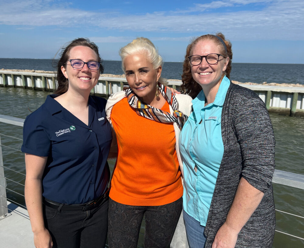 Kathy Sweezey of The Nature Conservancy, Lisa Halili of Prestige Oysters, and Laura Picariello of Texas Sea Grant at Texas A&M, pose near the site of Rett Reef.