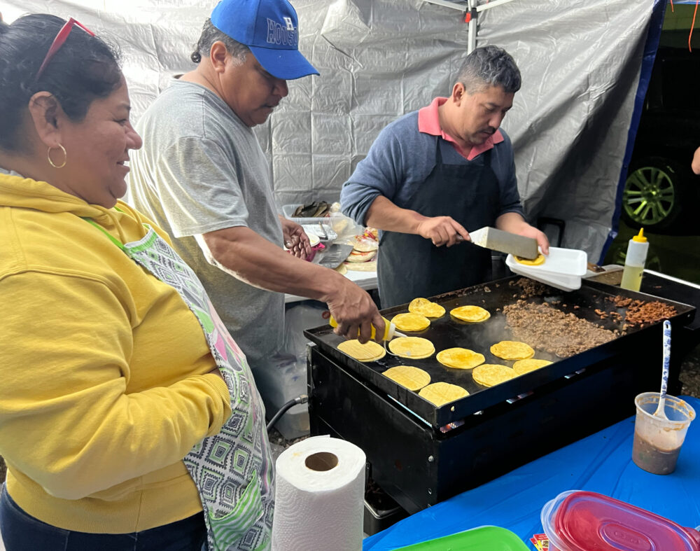Vendors make street tacos outside Coliseo Houston