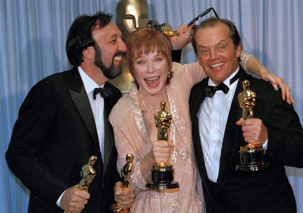 Director James L. Brooks shares a happy moment with actors Shirley MacLaine and Jack Nicholson after their film "Terms of Endearment," won five Oscars at the 56th annual awards in Los Angeles, April 10, 1984.