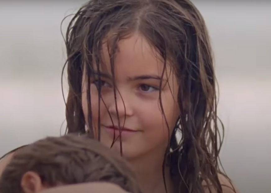 a young girl with wet hair at the beach