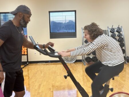 Cecilia “Cece” Voytek with instructor Justin Flakes at a fitness class held by the recreation center
