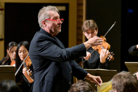 Photo of conductor leading orchestra
