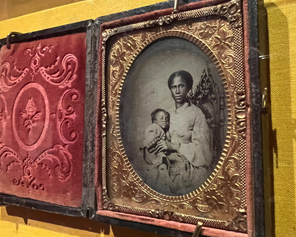 A tintype photo of an unknown African American woman and her baby