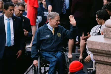 Gov. Greg Abbott high fives a young supporter after delivering a speech at a Parent Empowerment Day event at the Capitol on March 21, 2023. Credit: Jordan Vonderhaar for The Texas Tribune