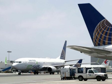 LOS ANGELES, CALIFORNIA - JUNE 05: A United Airlines Boeing 737-900ER (L), billed as a 'flight for the planet', arrives at Los Angeles International Airport (LAX) on 'World Environment Day' on June 5, 2019 in Los Angeles, California. The flight from Chicago to Los Angeles utilized aviation biofuel, carbon offsetting and efforts at zero carbon cabin waste. The airline says the flight was the 'most eco-friendly commercial flight of its kind in the history of aviation'.  (Photo by Mario Tama/Getty Images)