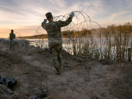 EAGLE PASS, TEXAS - JANUARY 10: Texas National Guard soldiers install additional razor wire lie along the Rio Grande on January 10, 2024 in Eagle Pass, Texas. Following a major surge of migrant border crossings late last year, miles of razor wire as well as huge quantities of refuse remain along the U.S.-Mexico border at Eagle Pass. (Photo by John Moore/Getty Images)