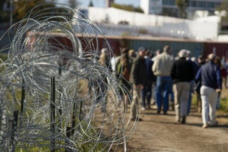 Concertina wire lines the path as members of Congress tour an area near the Texas-Mexico border, Jan. 3, 2024, in Eagle Pass, Texas. A divided Supreme Court on Monday, Jan. 22, allowed Border Patrol agents to cut razor wire that Texas installed on the U.S.-Mexico border, while a lawsuit over the wire continues