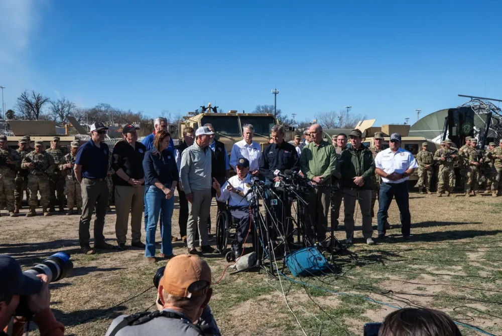 Flanked by visiting Republican governors, Texas Gov. Greg Abbott speaks to the press in Eagle Pass on Feb. 4, 2024. 