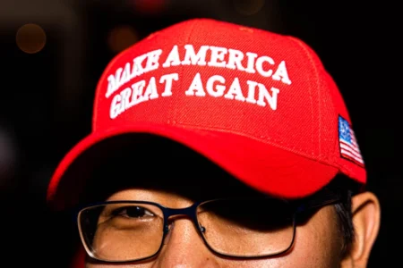 An attendee of the Travis County GOP election watch party in November 2022 wears a MAGA hat.