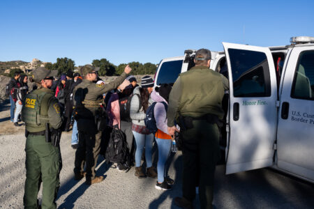 SAN DIEGO, CALIFORNIA - FEBRUARY 13: Migrants get on the patrol vehicle of the U.S. Border Patrol on February 13, 2024 in San Diego, California. (Photo by Qian Weizhong/VCG )