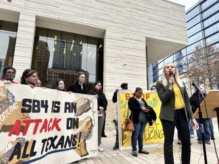 Kristin Etter, director of policy and legal services at the Texas Immigration Law Council, talks to opponents of Senate Bill 4 outside the federal courthouse in Austin on Thursday, February 15, 2024.
