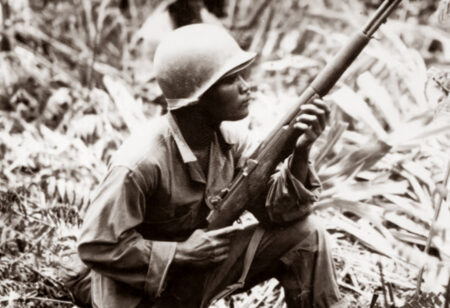 A Black soldier in action in the Pacific during World War II