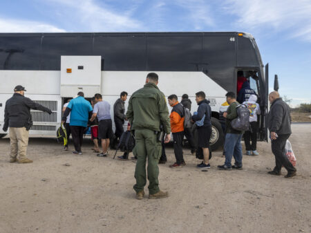 EAGLE PASS, TEXAS - JANUARY 07: Immigrants file into a U.S. Customs and Border Protection bus after crossing the U.S.-Mexico border on January 07, 2024 in Eagle Pass, Texas. According the a new report released by U.S. Department of Homeland Security, some 2.3 million migrants, mostly from families seeking asylum, have been released into the U.S. under the Biden Administration since 2021.