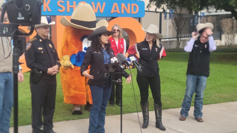 Harris County Judge Lina Hidalgo celebrates the beginning of the Houston Livestock Show and Rodeo at a press conference announcing the first "Hat Toss Day".