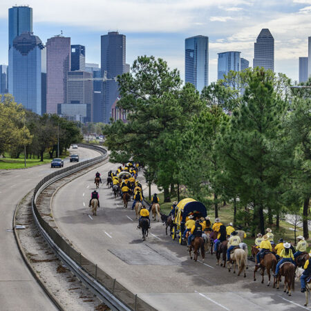 The annual rodeo parade approaches downtown Houston.