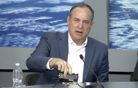 Intuitive Machines CEO Steve Altemus demonstrates how Odysseus may have landed on the moon on its side during a press conference at NASA's Johnson Space Center on Friday afternoon.