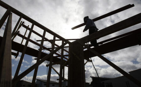 A worker carries wood at a housing complex in Palo Alto, Calif., Wednesday, Feb. 16 , 2011. Home construction rose at the fastest rate in 20 months, pushed up by a spike in apartment building. But construction of single-family homes declined, a sign that demand for housing remains weak. (AP Photo/Paul Sakuma)