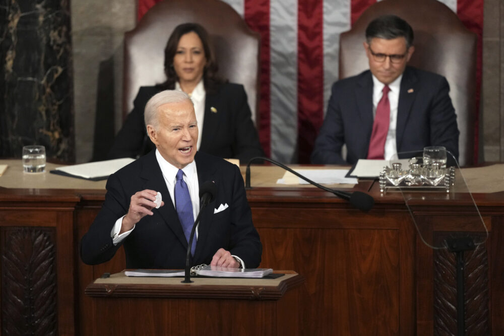 President Joe Biden holds a Laken Riley button as delivers the State of the Union address to a joint session of Congress at the U.S. Capitol, Thursday March 7, 2024.