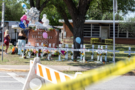 Police boundary markers surround Robb Elementary School in Uvalde on May 26 following the mass shooting two days earlier.