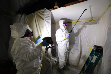 FILE - Asbestos Removal Technologies Inc. staff work on asbestos abatement in Howell, Mich., Oct. 18, 2017. The Environmental Protection Agency on Monday, March 18, 2024, announced a comprehensive ban on asbestos, a carcinogen that kills tens of thousands of Americans every year but is still used in some chlorine bleach, brake pads and other products. (AP Photo/Paul Sancya, File)