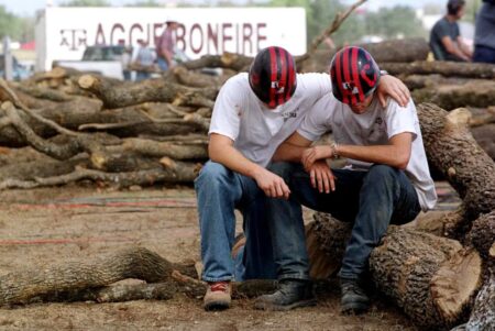 Texas A&M students mourn the loss of fellow students after a bonfire log structure collapsed on Nov. 18, 1999, in College Station, killing 12. The bonfire, made of thousands of logs, was a longtime annual tradition ahead of the school's football game against the University of Texas at Austin. Credit: Adrees A. via REUTERS