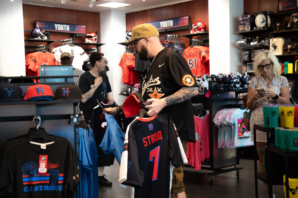 Houston Texans fans browse through the NRG fan shop in search for the perfect swag ahead of the season as the team unveils their new uniform on April 23, 2024. (Photo Credit: Daisy Espinoza / Houston Public Media)