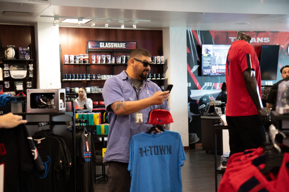 Houston Texans fans browse through the NRG fan shop in search for the perfect swag ahead of the season as the team unveils their new uniform on April 23, 2024. (Photo Credit: Daisy Espinoza / Houston Public Media)