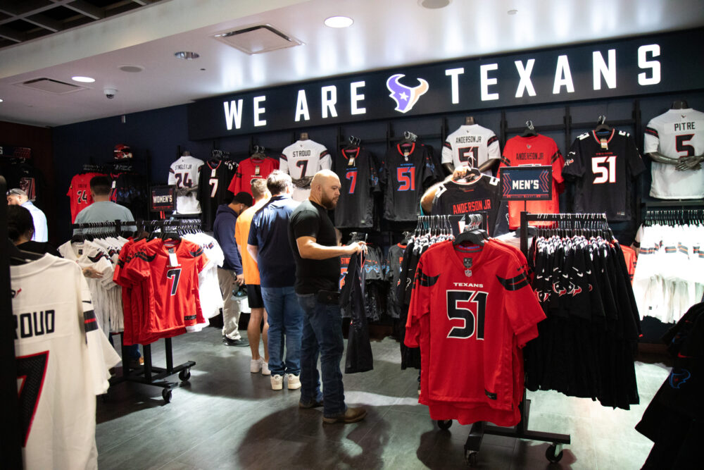 Houston Texans fans browse through the NRG fan shop in search for the perfect swag ahead of the season as the team unveils their new uniform on April 23, 2024. (Photo Credit: Daisy Espinoza / Houston Public Media)