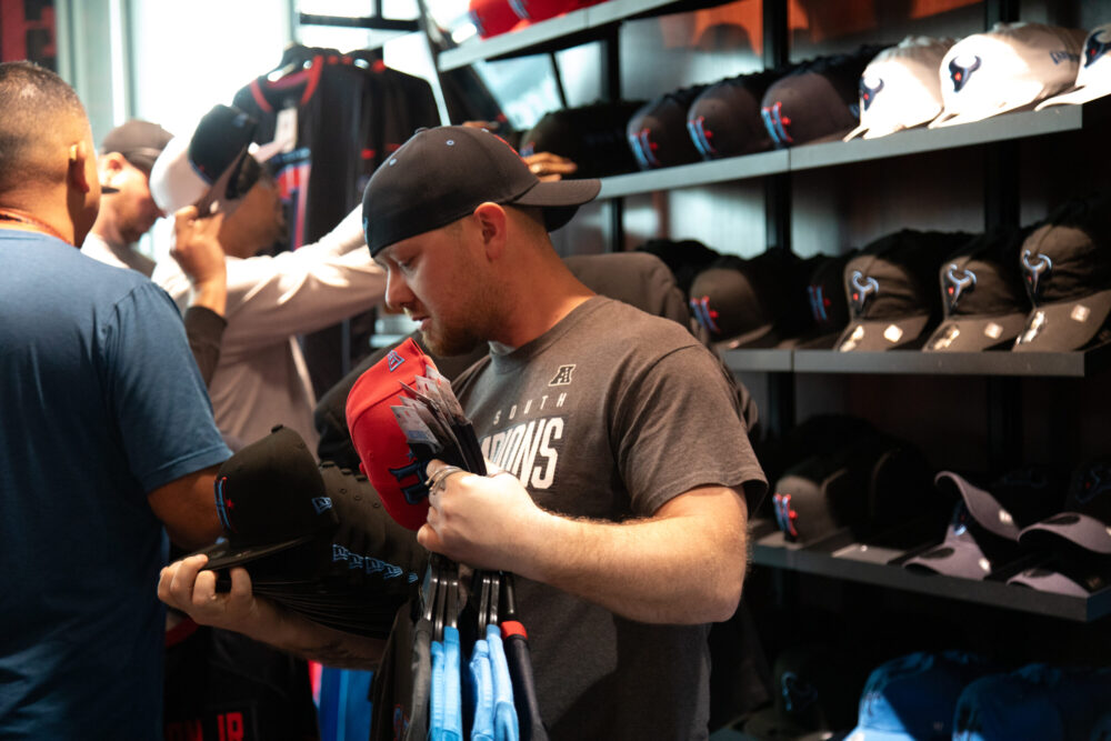 Houston Texans fans browse through the NRG fan shop in search for the perfect swag ahead of the season as the team unveils their new uniform on April 23, 2024. (Photo Credit: Daisy Espinoza / Houston Public Media)