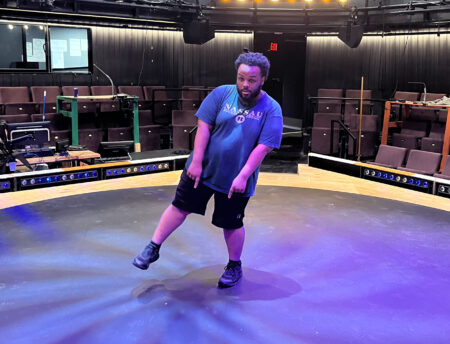 An actor rehearses on stage