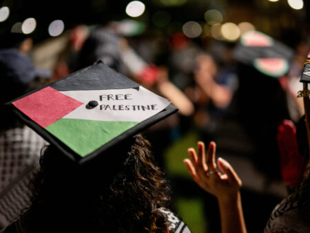 AUSTIN, TEXAS - MAY 11: Graduate students and demonstrators protest the war in Gaza after walking out of commencement at the DKR-Texas Memorial Stadium on May 11, 2024 in Austin, Texas. Amid nationwide tension on college campuses over the war between Israel and Hamas, students continue protesting and calling for universities to divest from Israel.  (Photo by Brandon Bell/Getty Images)