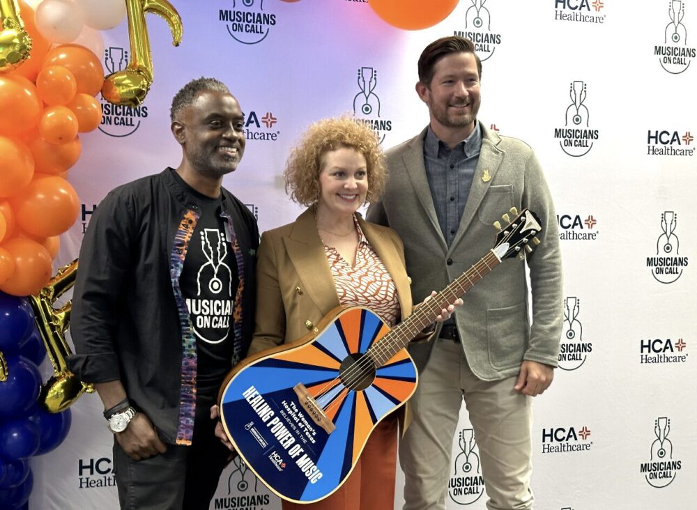 (L-R) Volunteer musician Lain Gray, Jeanna Bamburg, CEO of Woman's Hospital of Texas, and Pete Griffin, CEO of Musicians on Call, pose at the organization's launch event in Houston in April 2024.