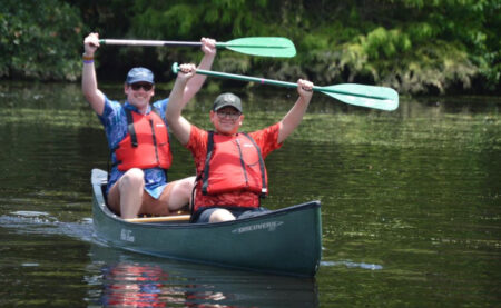 A canoeing expedition around the lake at Camp for All in Burton, Texas.