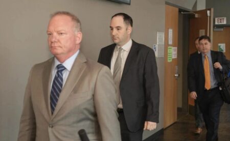Daniel Perry, center, and his attorney Doug O’Connell walk out of court during jury deliberations in his murder trial last year.