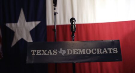 A Texas Democrats sign hangs on a podium at a Democratic watch party following a Texas primary election in Austin.