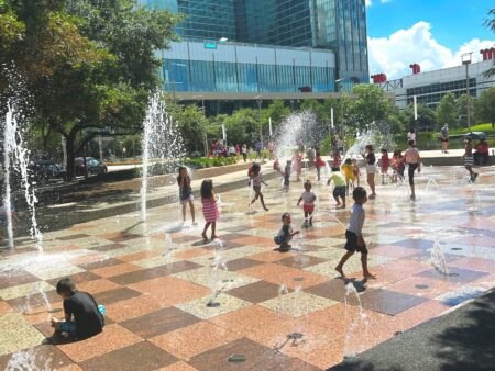 Children playing in the splash fountains at Discovery Green. 
