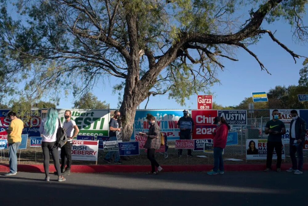 Voters wait in line outside Cody Public Library in San Antonio during the evening hours of Election Day, Oct. 23, 2020. Credit: Clint Datchuk for The Texas Tribune