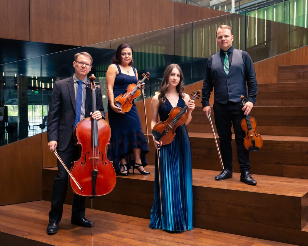 Photo of posed string quartet musicians