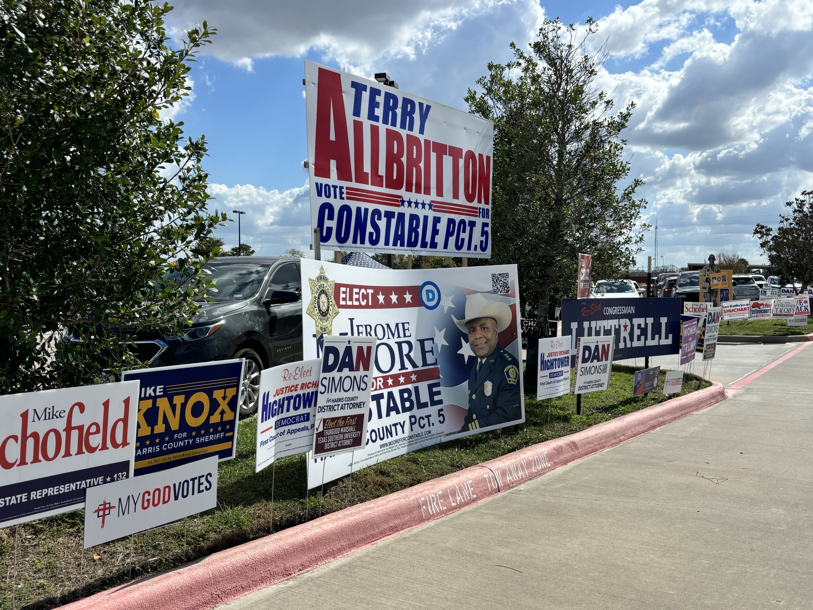 Political signs near an early voting site in Harris County in 2024.