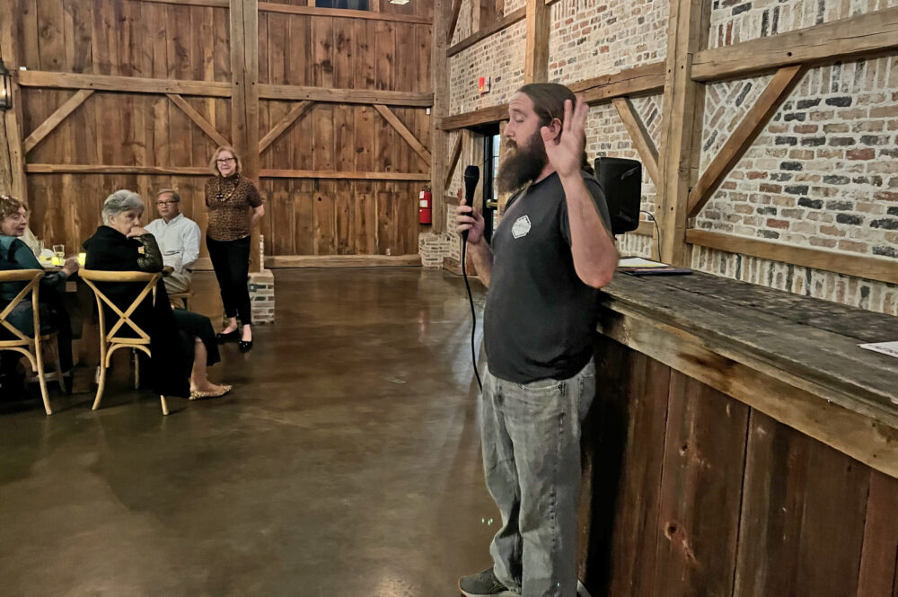 Mike Starr of Backyard Brewery tells participants about the medieval-style ale he brewed for the dinner. (Photo Credit: Michael Hagerty/Houston Public Media)