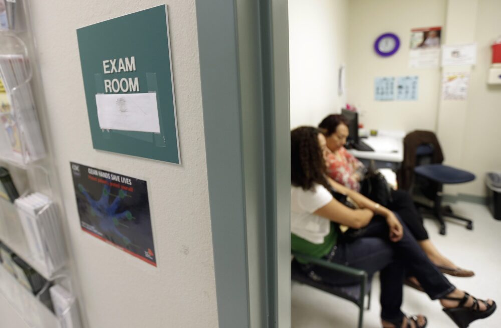 In this July 12, 2012 file photo, two women wait in an exam room at Nuestra Clinica Del Valle, in San Juan, Texas. About 85 percent of those served at the clinic are uninsured. (AP Photo/Eric Gay)