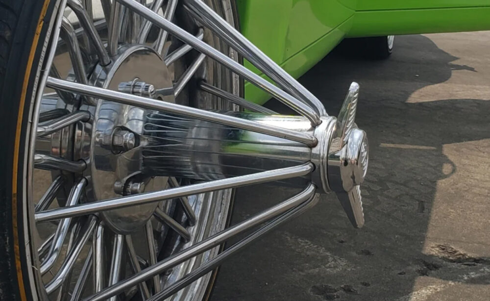 A closeup of spokes on the rim of a custom car