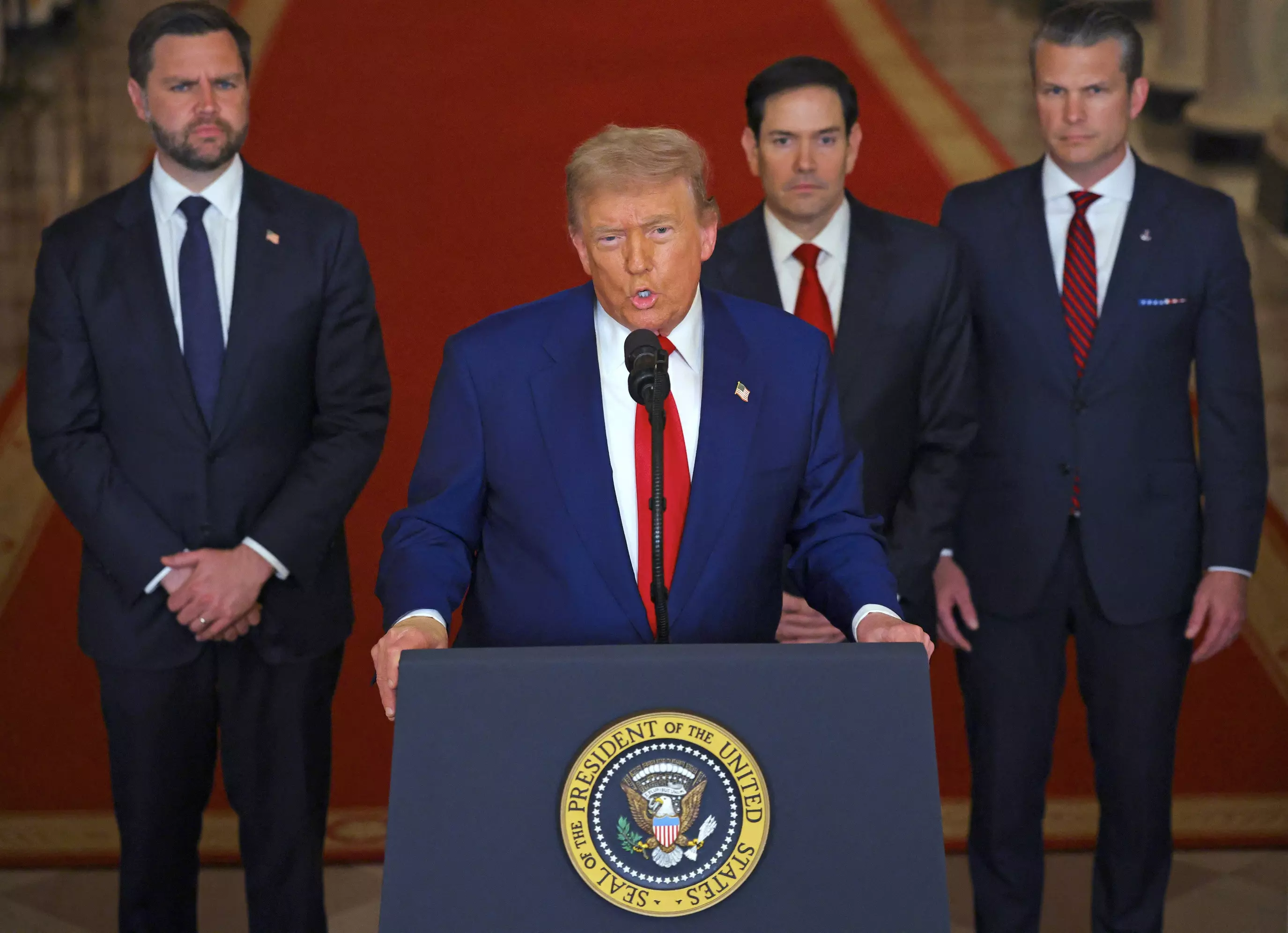 President Trump addresses the nation, alongside US Vice President JD Vance (L), US Secretary of State Marco Rubio (2nd R) and US Secretary of Defense Pete Hegseth (R), from the White House on Saturday.