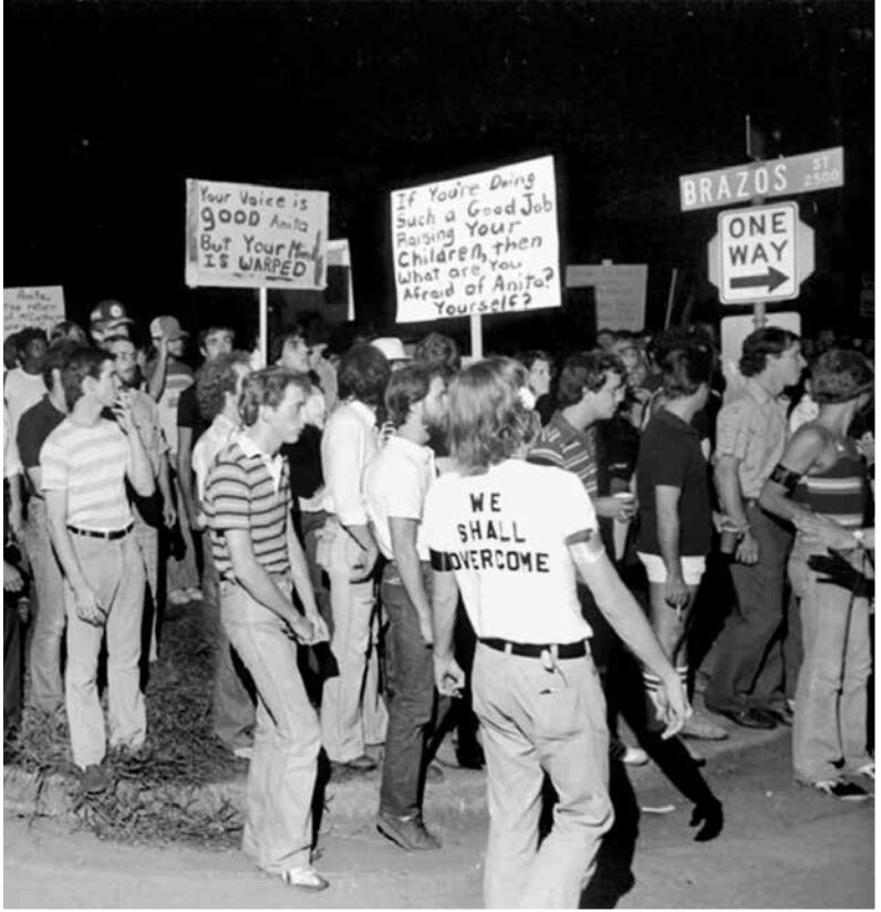 Protestors hold signs denouncing antigay activist Anita Bryant in 1977