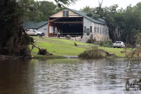 Law enforcement agents outside of a torn building at Camp Mystic on Sunday, July 6, 2025. Law Enforcement and volunteers are in search for missing people due to heavy rainfall the caused flooding along Guadalupe River.