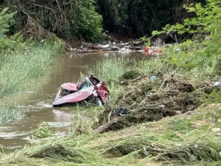 A car and other debris pushed into the creek at Perrin Beitel.