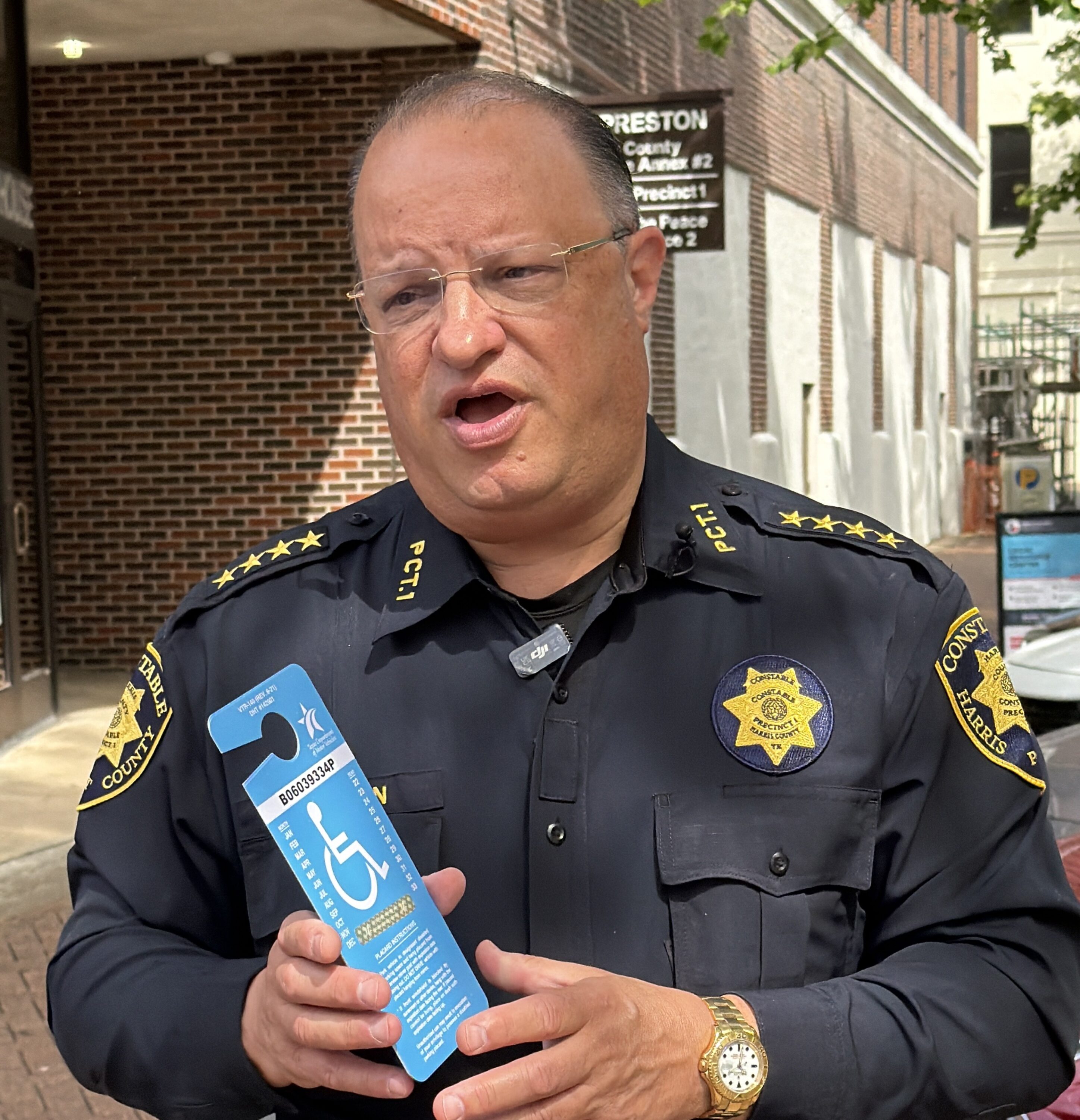 Harris County Precinct 1 Constable Alan Rosen holds a fake handicap placard.