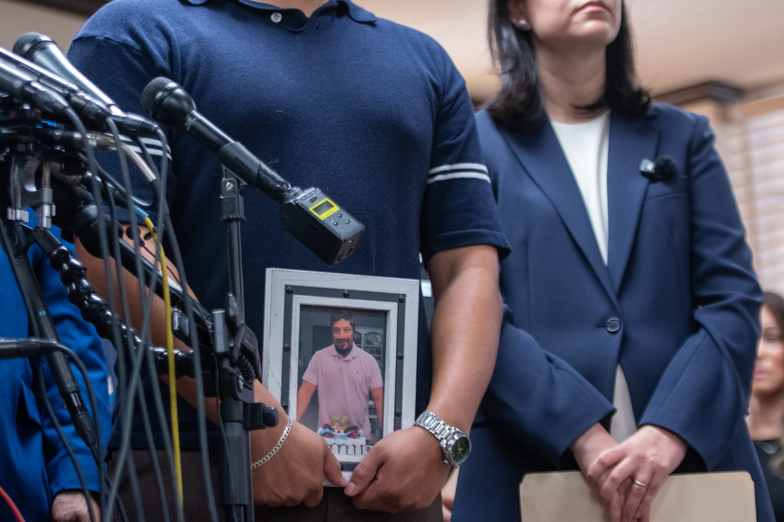 Ronaldo Salgado holds a photo of his father, who was shot and killed by an ICE agent, at a press conference. July 8, 2026.